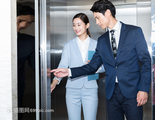 商务男女准备坐电梯上班工作